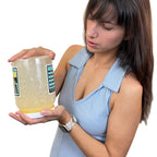 Young women watching oozing simulated fat in Vat of Fat, health education jar representing extra calories, Health Edco 79129
